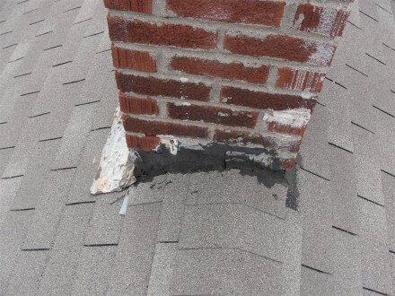 Tar patching at chimney flashing